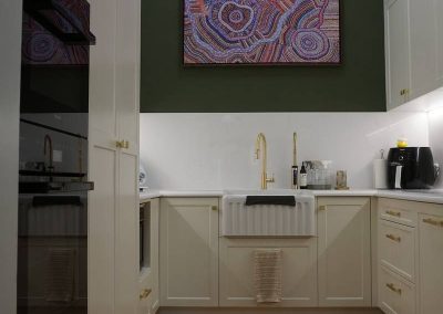 white kitchen cabinet with wooden flooring