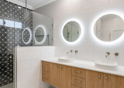 white bathroom with two mirrors and vanity 2025